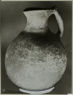Globular jug with a tall neck and single loop handle, from the Vrysi tou Barba tombs at Lapithos