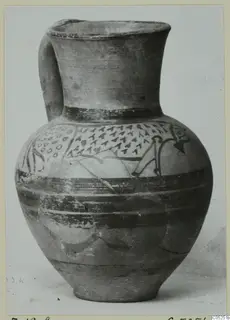 Pottery bowl-jar with a single strap handle and painted triangles, dots and bands, photographed against a pale background