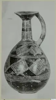 Pottery Red Polished II jug with a single handle, a flared mouth and white painted bands and hatched diagonal patterns