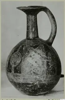 Dark jug with a single loop handle, incised neck bands and concentric circles on the body, from Lapithos