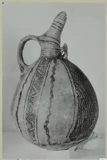 White Painted I - II jug from the Vrysi tou Barba tombs at Lapithos, shown whole against a plain backdrop