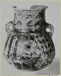 Two-handled painted pottery amphora with a flared rim, photographed from the front against a plain background