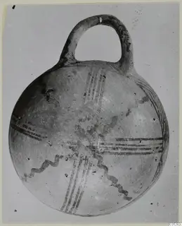 Pottery White Painted III-2 bowl from the Vrysi tou Barba tombs at Lapithos, with a loop handle and dark painted bands