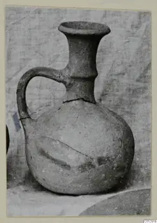 Pottery jug with a wide flaring mouth and strap handle, Plain White I-III, from Lapithos Kastros tombs.