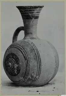 Pottery Bichrome III single-handled jug with dark painted bands and concentric circles on its body