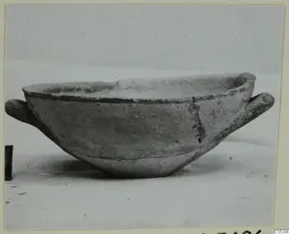 Pottery bowl with two small horizontal handles, from the Kastros tombs at Lapithos, seen in side view.