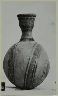 Round-bodied pottery vessel with a tall narrow neck, painted with dark bands and stripes, from Lapithos