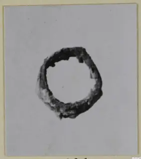 Corroded bronze ring from Lapithos, shown centred on a pale card background.