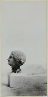 Terracotta female head in profile on a square block base, from Soli