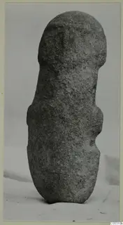 Worked stone object from Petra tou Limniti, standing upright on a light cloth