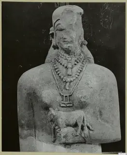 Limestone statue bust with layered bead necklaces and a small animal carved at the chest