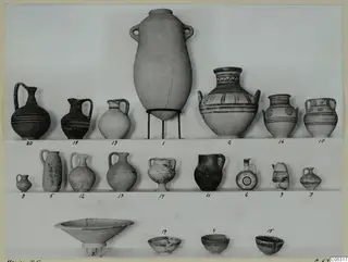 Twenty numbered pottery vessels, jugs, jars and bowls, set out in three rows against a plain backdrop