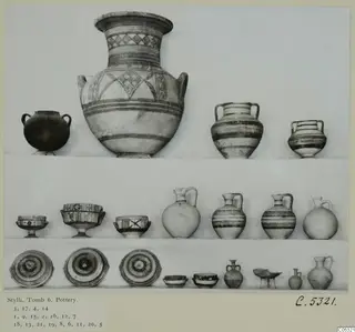 Pottery vessels from Stylli, Tomb 6, arranged in three rows: two-handled jars, jugs, footed bowls and shallow dishes.
