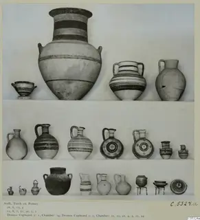 Pottery vessels from Tomb 10 at Stylli, arranged on three shelves against a plain background.