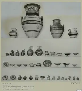 Pottery vessels from Tomb 17 at Stylli, arranged in rows on shelves against a pale background