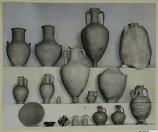 Group of pottery vessels from Tomb 52 at Marion, arranged in three rows: jugs, two-handled amphorae, jars and small bowls.
