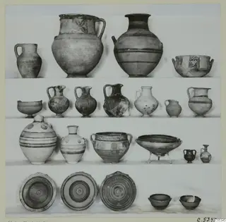 Pottery vessels from Marion Tomb 68 arranged in four rows: jugs, jars, bowls and plates.