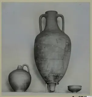 Three pottery vessels from Marion, Tomb 54: a tall two-handled jar, a small jug and a low bowl.