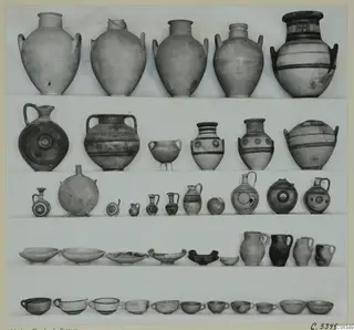 Pottery vessels from Marion, Tomb 98, set out in rows on a pale background