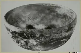 Large shallow bowl of cast glass, photographed from above at an angle.
