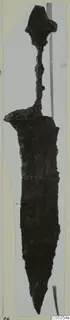 Iron weapon with a pointed blade, a narrow grip and a flared knob-shaped top, photographed upright against a grey background.