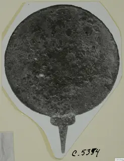 Round metal disc with a narrow tang, from Marion