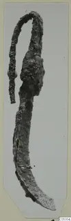 Corroded metal curved tool with a looped upper end, from Marion