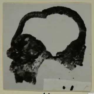Corroded fragment of an object with a curved loop, part of an object from Marion