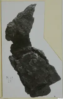 Corroded iron axe from Marion, shown on a card mount
