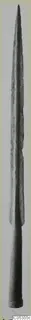 Long bronze blade tapering to a point, with a cylindrical base, photographed upright against a grey backdrop.