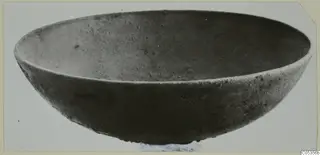 Bronze bowl from Marion Tomb 73, wide and shallow, photographed at an angle.