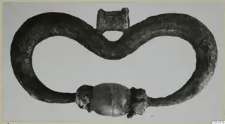 Silver pendant from Marion: a figure-eight loop of metal with a central oval bead at the bottom