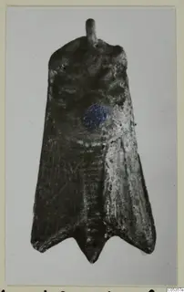 Flat, dark metal object from Vouni with a short rod at the top and a forked lower end