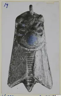 Silver-coloured metal object from Vouni, flat and tapering, with a loop at the top and blue-painted patches on the upper part.
