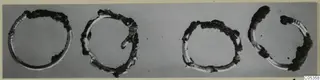 Four bronze rings from Vouni shown side by side, with dark corrosion on parts of each.