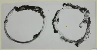 Two corroded bronze rings from Vouni, photographed on a pale card