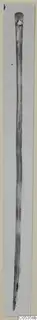 Long pin with a thickened, rounded head, shown upright against a pale background, from Vouni