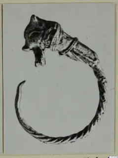 Small animal-headed figure curled into a ring, from Marion