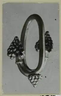 Jewellery from Marion: an oval metal loop with three clusters of small knobs attached