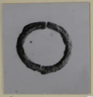 Ring-shaped metal jewellery from Amathus, photographed on a pale grey card