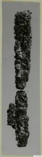 Two corroded iron fragments, probably an iron weapon in two broken pieces, shown on a grey background