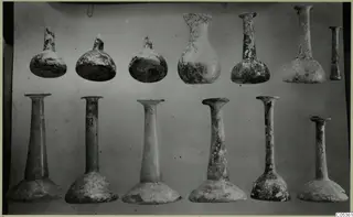Blown glass vessels from Amathus, arranged in two rows against a plain background