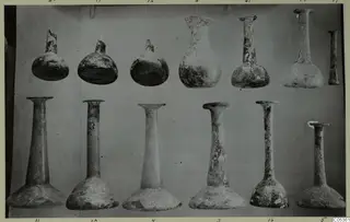 Blown glass vessels from Amathus, twelve pieces arranged in two rows against a plain backdrop