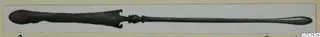 Long metal object with a broad, notched end, a small central knob and a slender shaft tapering to a rounded tip, from Amathus