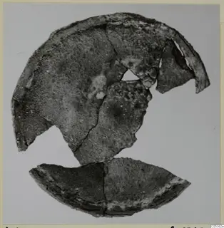 Corroded bronze fragments of a broken rounded object from Amathus, shown on a plain background