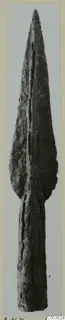 Bronze spearhead from Amathus, a long leaf-shaped blade with a central ridge, shown upright on a mounted print.