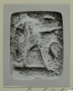 Rectangular stone seal from Amathus, its face carrying raised, worn relief shapes
