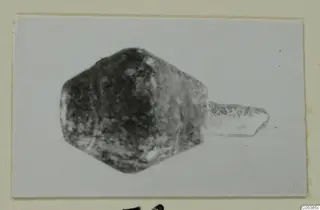 Find from Amathus: a dark angular object with a pale part projecting to one side.