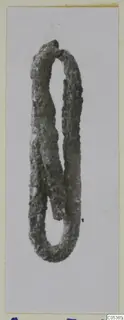 Silver pin from Amathus, heavily corroded and bent into a long loop with overlapping ends.