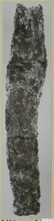 Corroded iron tool from Amathus, long and narrow, shown upright against a plain light background